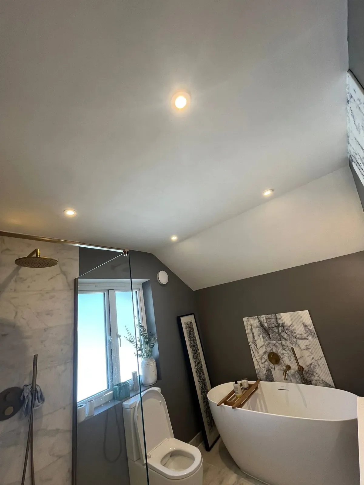 Finished bathroom with downlights in the sloped ceiling