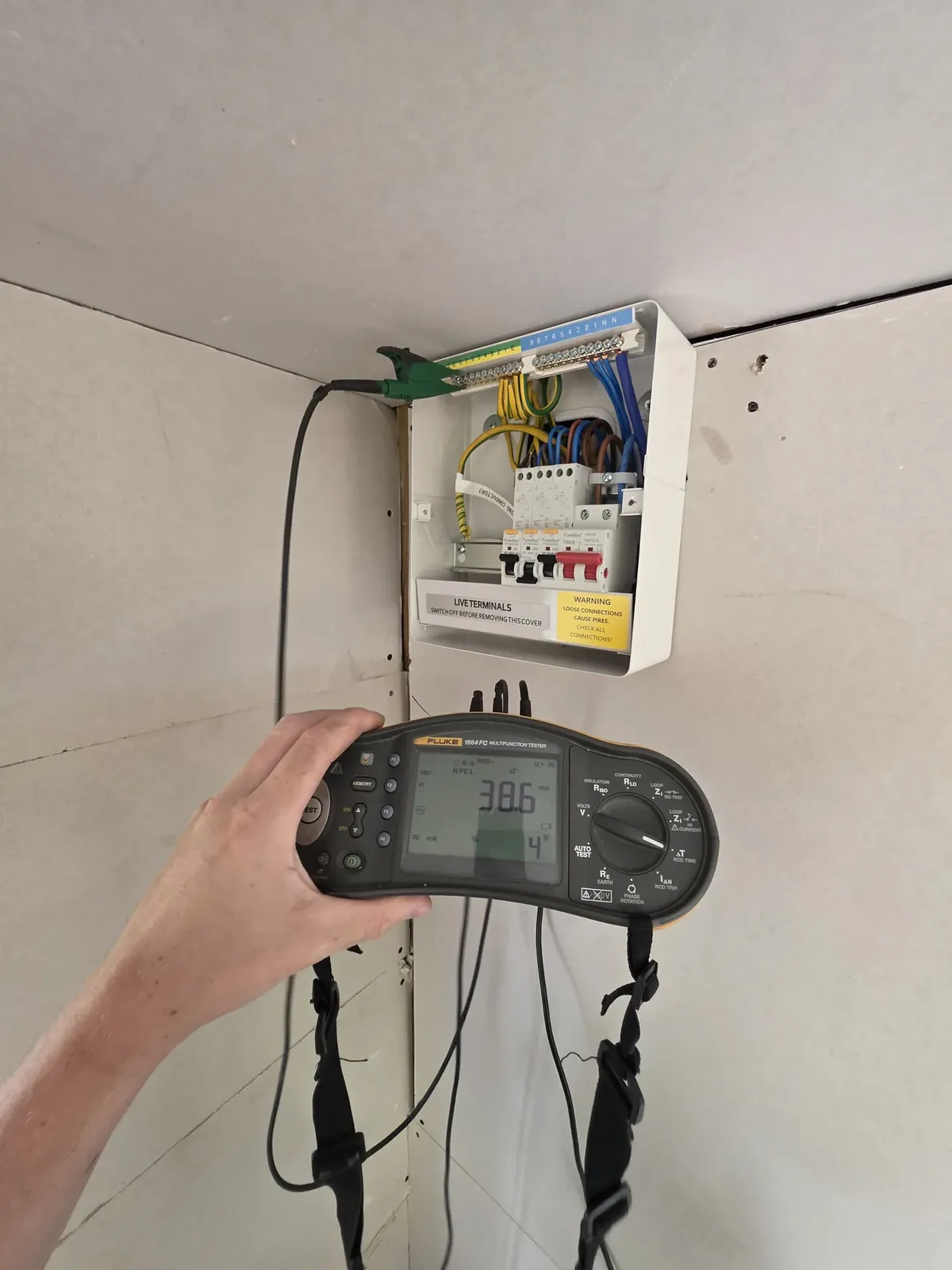 Tester reading taken on a newly installed consumer unit with the cover off