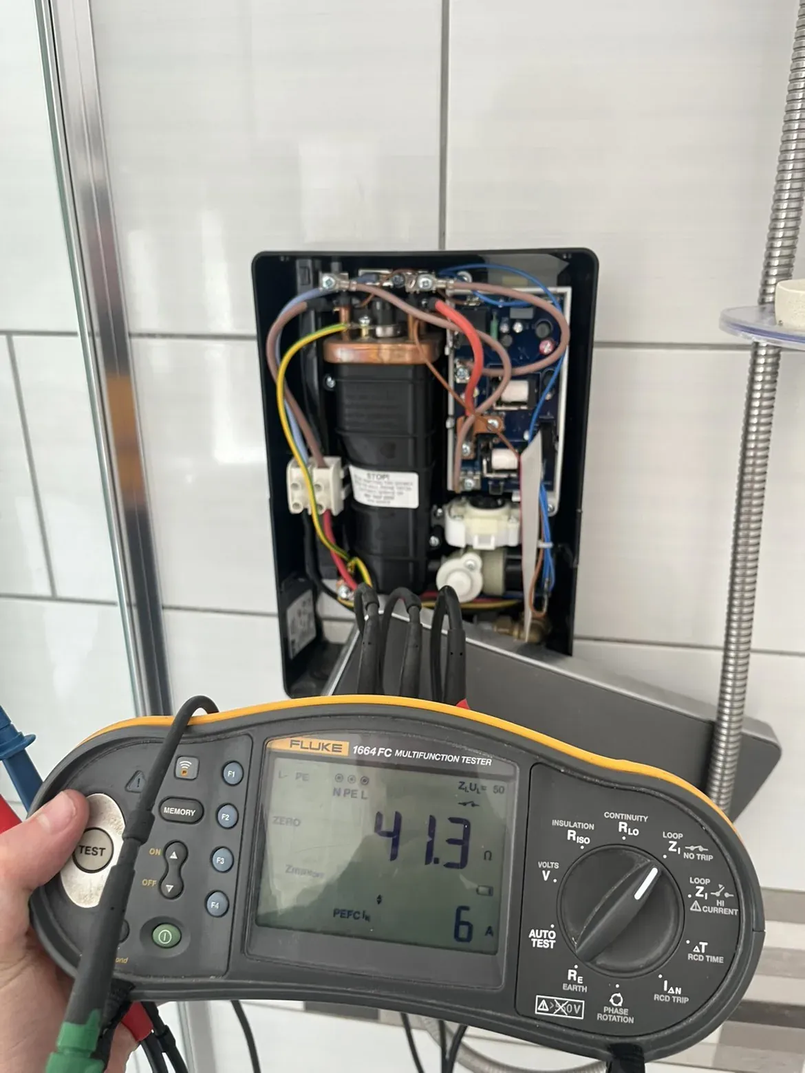 Electric shower circuit tested with the cover removed