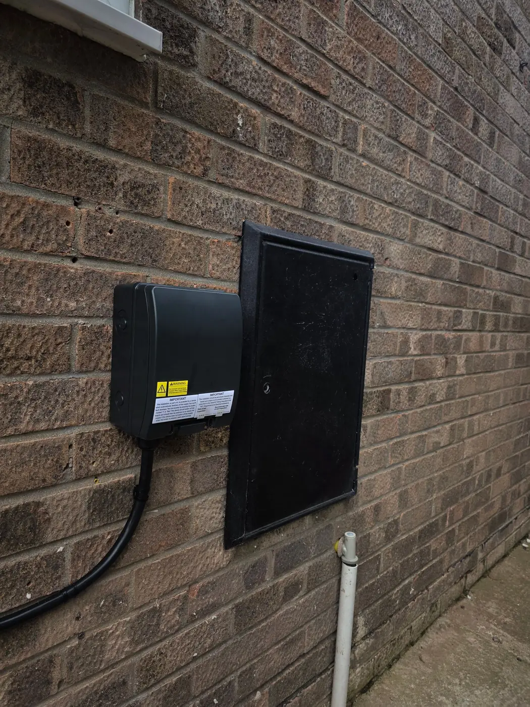 Weatherproof enclosure for the EV charger supply next to the external meter box