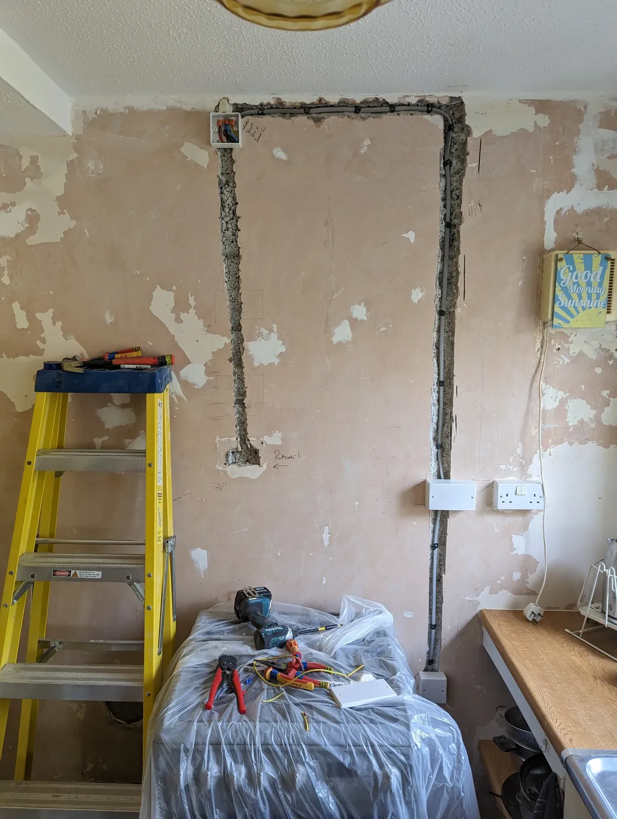 Kitchen wall chased out for new cable runs and sockets during a rewire