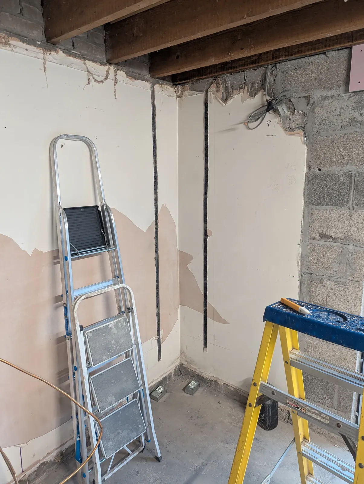 Room stripped back to bare joists with chased walls ready for new cabling