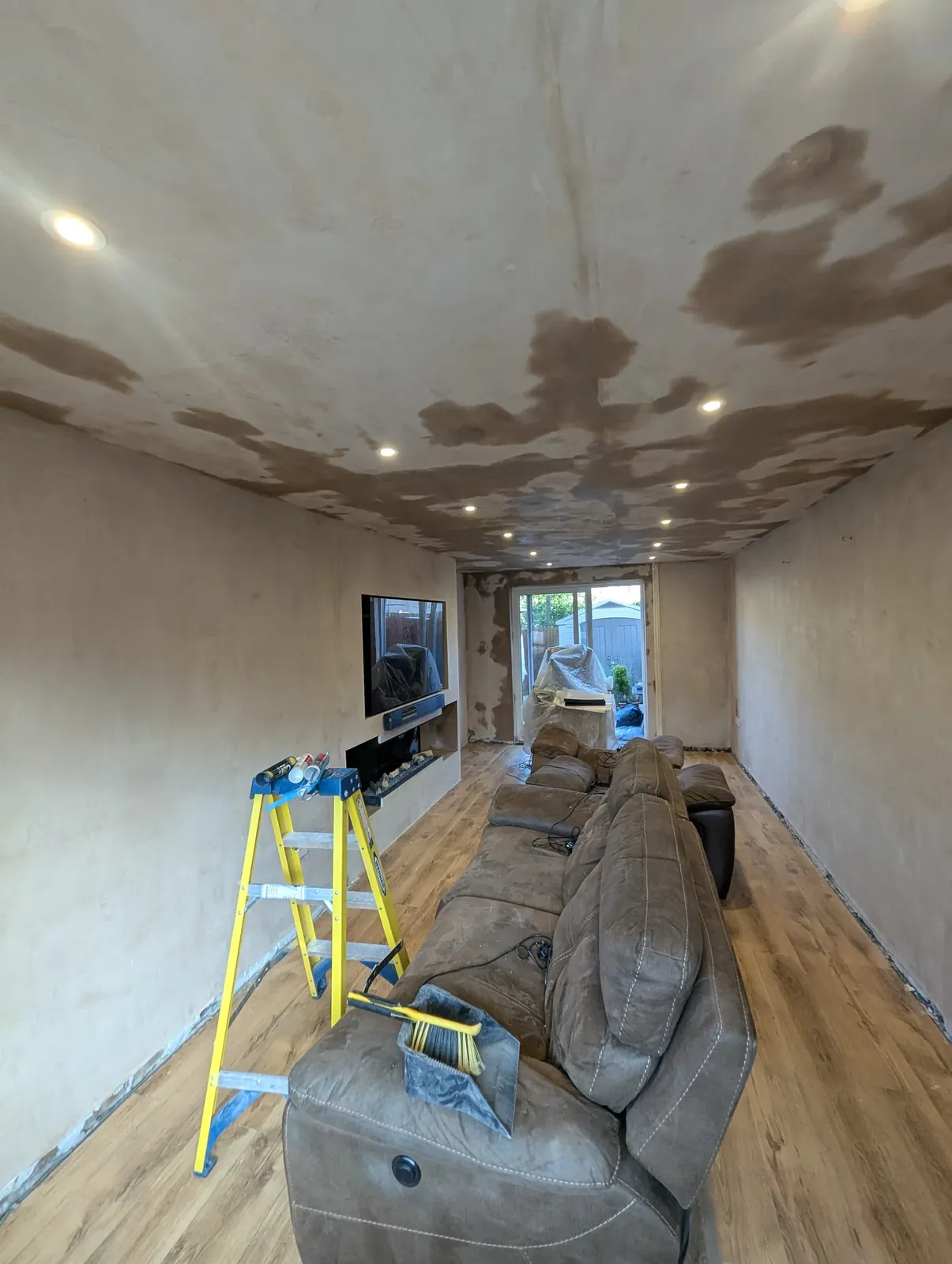 Living room ceiling patched after a rewire with new LED downlights fitted